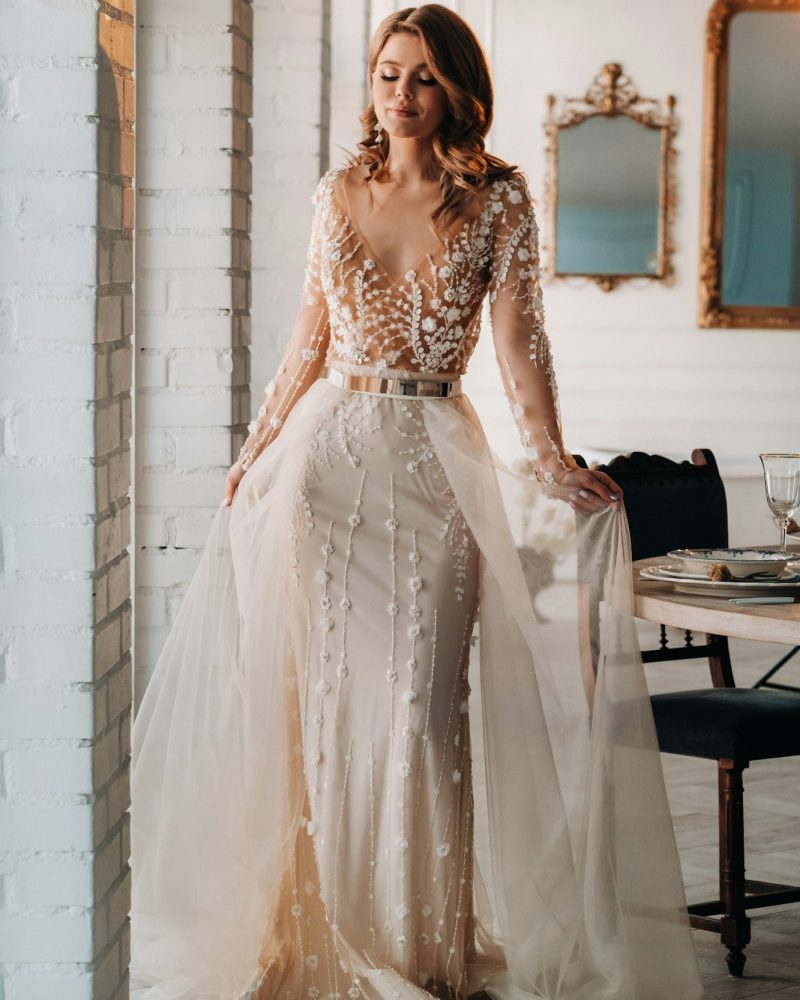 A luxurious bride in a wedding dress in the morning in her interior